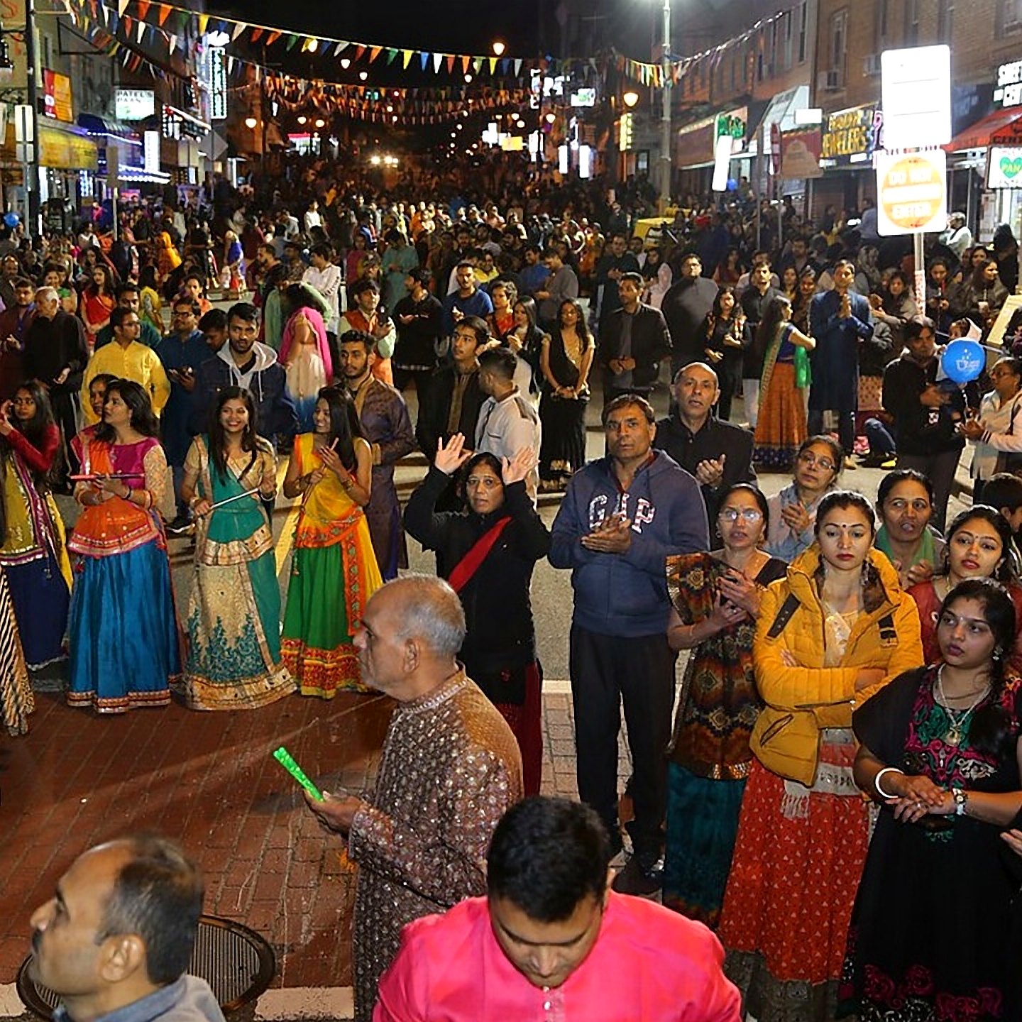 Crowd dancing garba on Newark Avenue at night