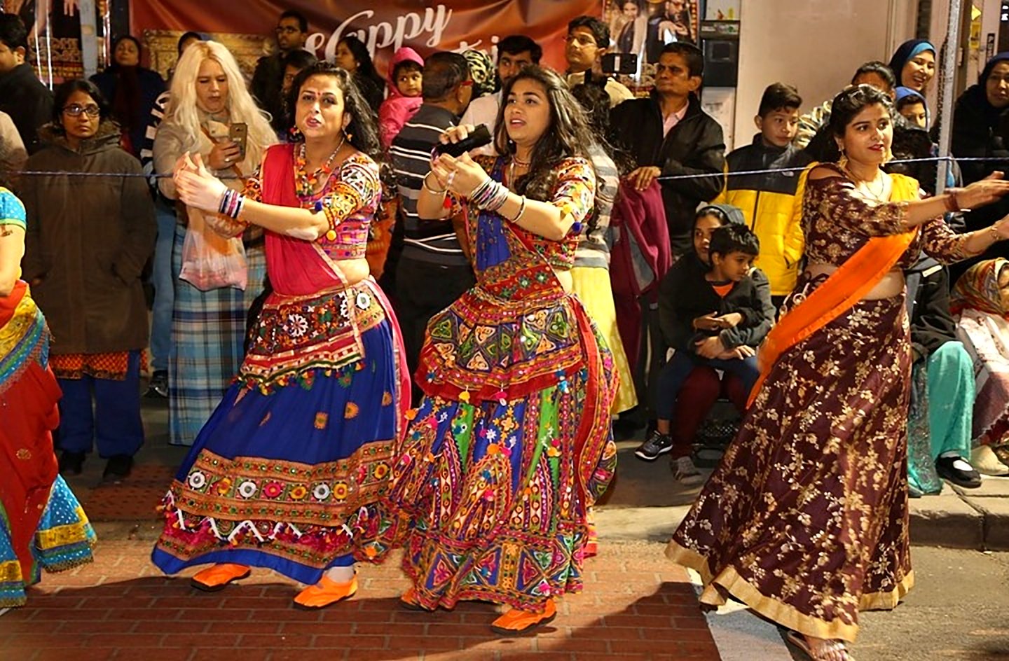 Dancers in mirror-work chaniya choli performing garba