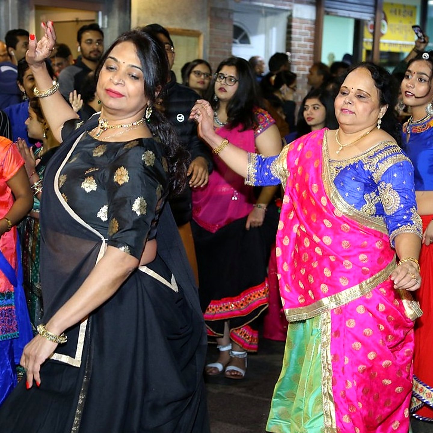 Women in silk saris dancing garba